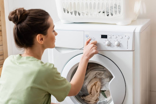 Homeowner looking at time left on the washer.