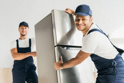 Appliance Doctors team moving big refrigerator.